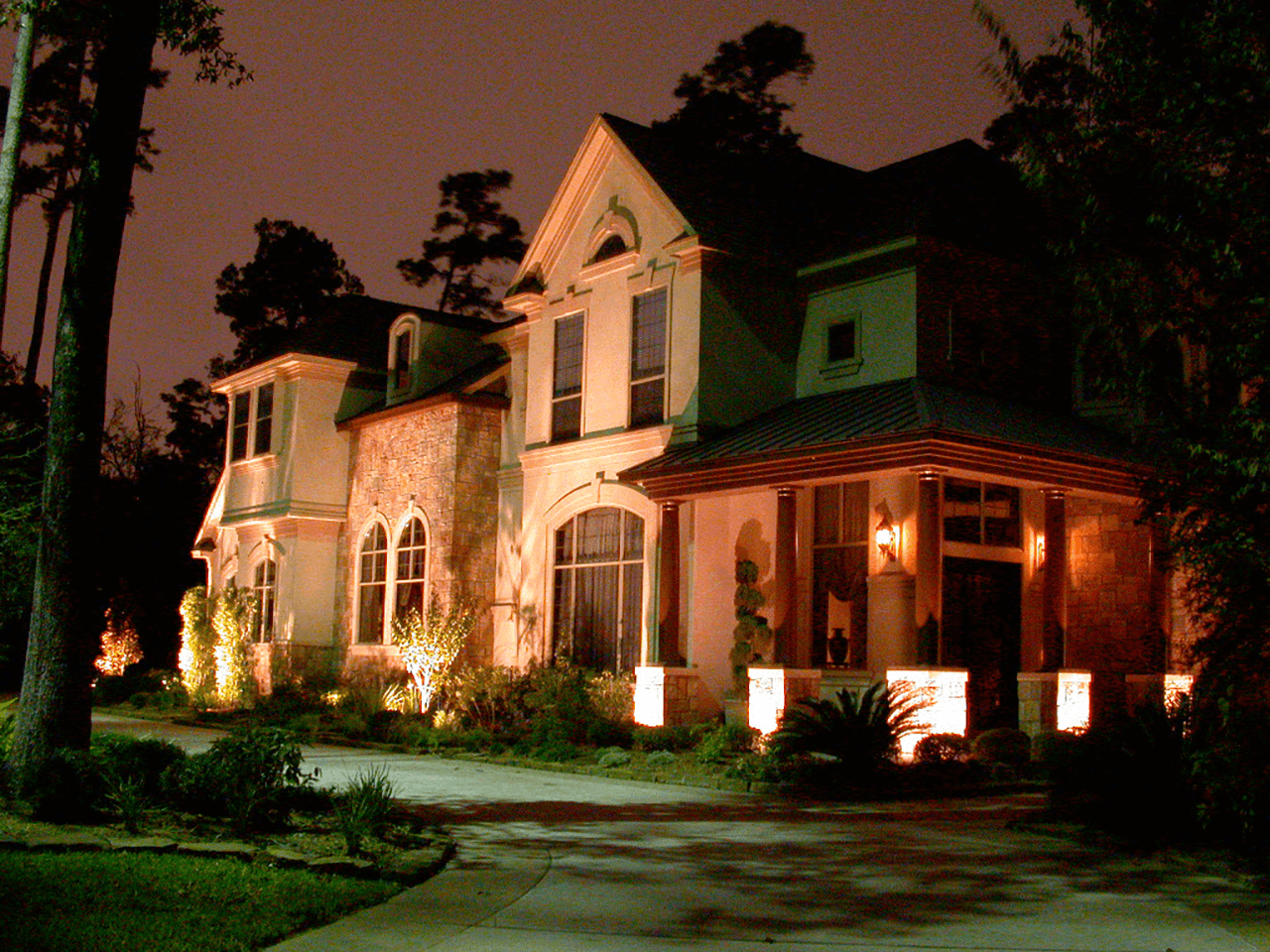 Side view of a house being lighted by soft yellow lights