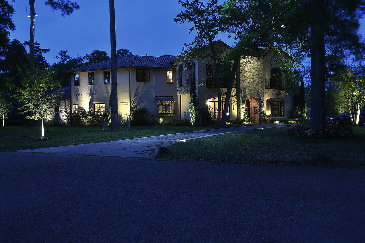 Street view of a house being lighted by soft yellow lights